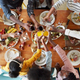 Family cheersing glasses around holiday table